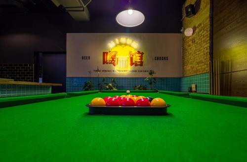 a pool table with a bowl of fruit on it at Tune Hotel KLIA-KLIA2, Airport Transit Hotel in Sepang