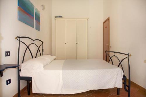a bedroom with two beds and a cabinet at Residence Luna Rossa in Costa Rei