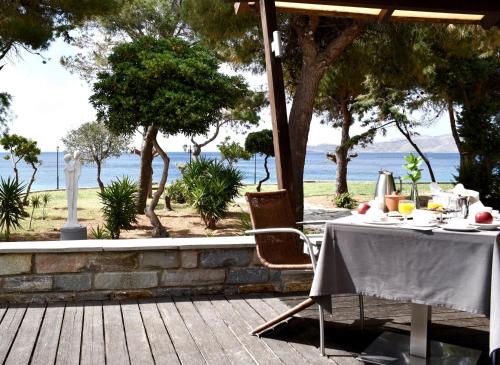 a picnic table set up on a patio overlooking the ocean at Karystion Hotel in Karistos