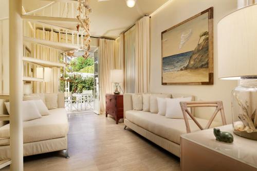 a living room with a couch and a table at Villa Roma Imperiale in Forte dei Marmi