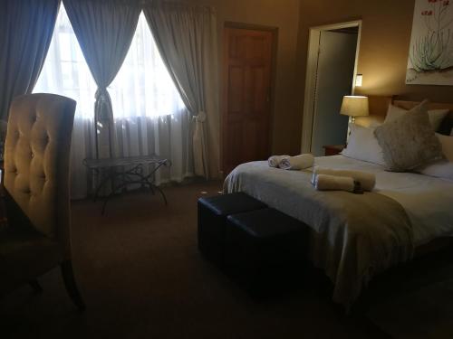 a hotel room with a bed and a window at Augrabies Falls Lodge & Camp in Augrabies