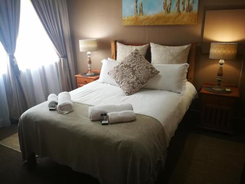 a bedroom with a bed with towels on it at Augrabies Falls Lodge & Camp in Augrabies