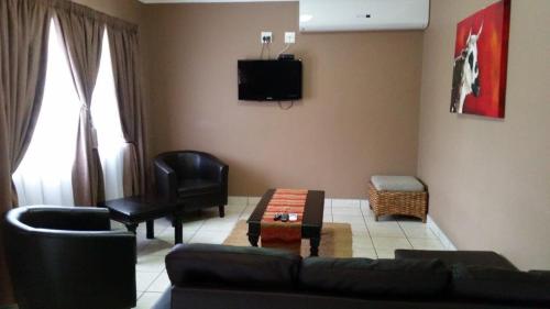 a living room with a couch and a chair at Augrabies Falls Lodge & Camp in Augrabies