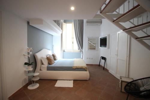 a bedroom with a large bed and a window at S'O Smart B&B Tropea in Tropea