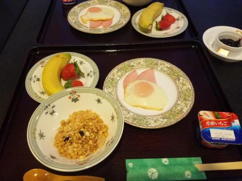 a table with plates of food on a tray at Hakuba Hotel Hana-no-Sato in Hakuba