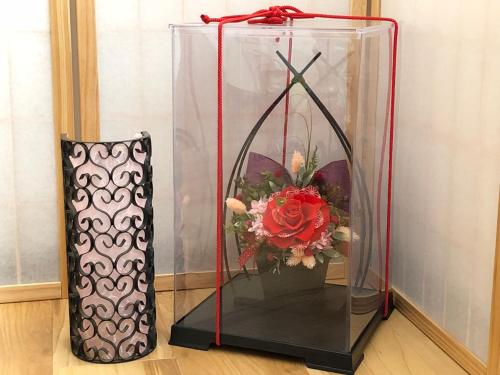 a vase with a flower in a glass dome at HISAYO'S INN in Tokyo