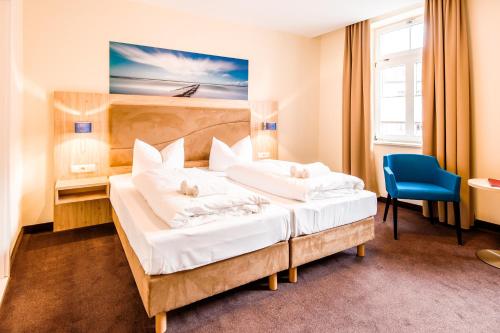 En eller flere senger på et rom på Hotel Am Alten Hafen
