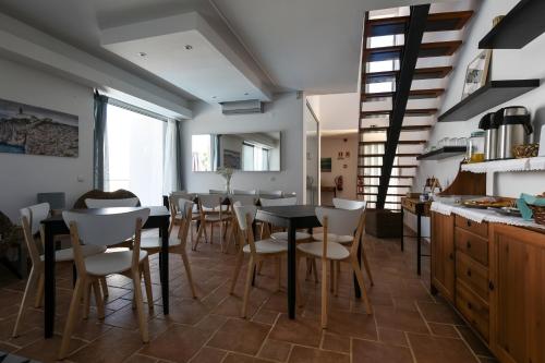 a kitchen and dining room with a table and chairs at Pé na Areia - Guest House in Vila Real de Santo António