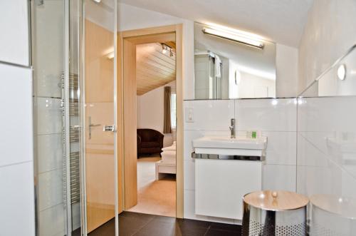 ein Bad mit einem Waschbecken und einem Spiegel in der Unterkunft Apartment Zita - GRIWA RENT AG in Grindelwald