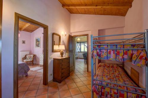 a bedroom with a bunk bed and a living room at Podere Lo Stringaio in Fauglia
