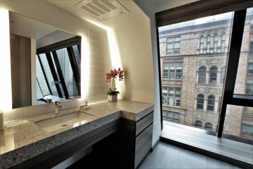 a bathroom with a sink and a large window at Carnegie Hotel in New York