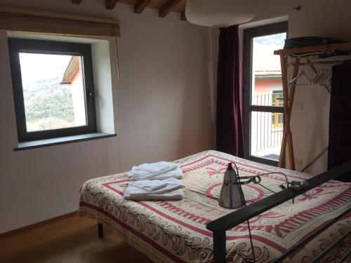 a bedroom with a bed with a tea kettle on it at Agriturismo Brasino in Fosdinovo