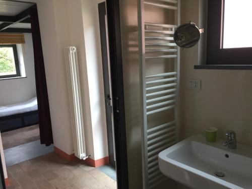 a bathroom with a sink and a glass shower door at Agriturismo Brasino in Fosdinovo