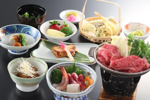 a group of bowls of food on a table at Shiga Lake Hotel in Yamanouchi