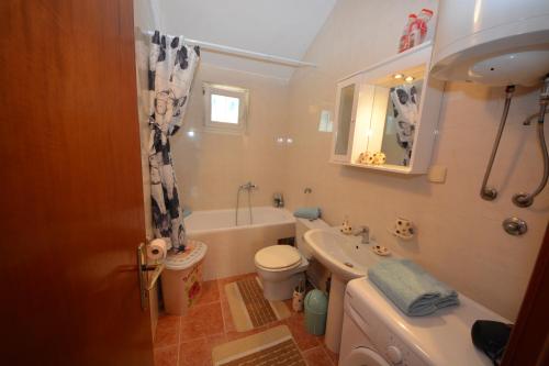 a bathroom with a sink and a toilet and a tub at Apartman Milošević in Kotor
