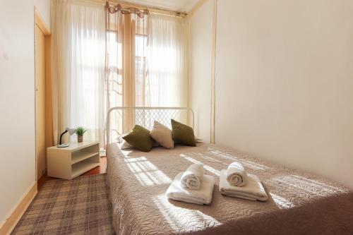 1 dormitorio con 1 cama con toallas en Ledi´s Housing, en Lisboa