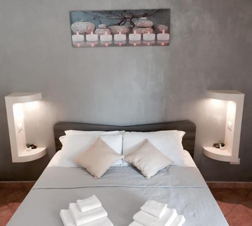 a bedroom with a bed with two white pillows at Residenza Dama in Santa Domenica