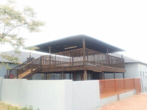 a building with a wooden deck on top of it at Vido Lodge and Conference Centre in Polokwane