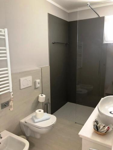 a bathroom with a toilet and a sink and a shower at Hotel Casa Marinella in Malcesine