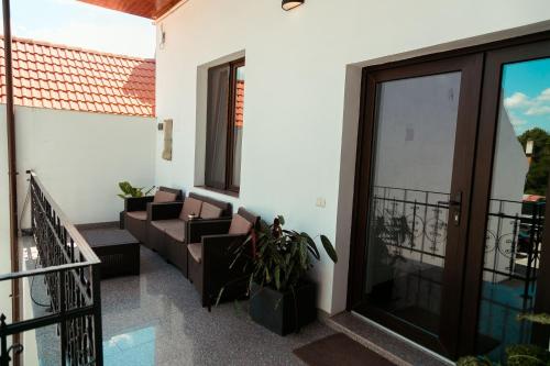 a balcony of a house with a couch at Elegant House in Făgăraş