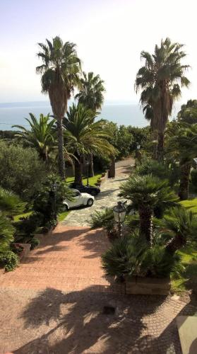 a car parked in a park with palm trees at Villa Amalia Srls in Gizzeria