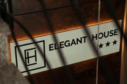 a sign for an element house on a building at Elegant House in Făgăraş