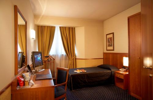 Ένα ή περισσότερα κρεβάτια σε δωμάτιο στο Pacific Hotel Fortino