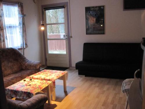 a living room with a couch and a coffee table at Silkeborg Sø Camping Apartments in Silkeborg