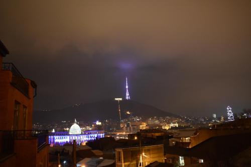a view of a city at night with a hill at SaBa Apartments in Old Tbilisi in Tbilisi City