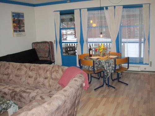 a living room with a couch and a table at Silkeborg Sø Camping Apartments in Silkeborg