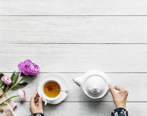 a woman holding a cup of tea and a tea pot at Lavanda in Umag