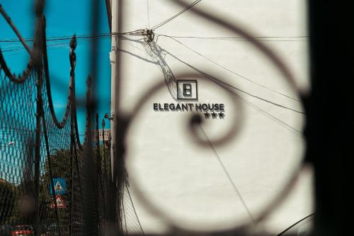 a building with a sign on the side of it at Elegant House in Făgăraş