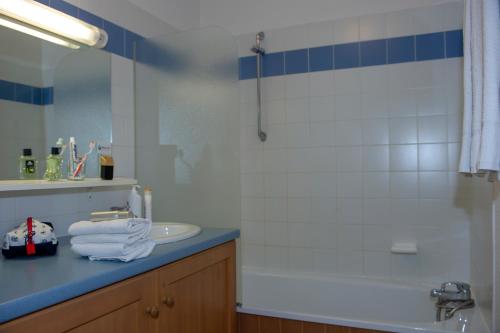 a bathroom with a sink and a shower and a tub at Résidence Goélia Les Balcons du Soleil in Les Deux Alpes