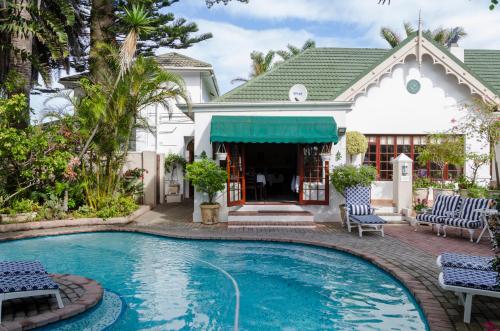 a swimming pool in front of a house at Brighton Lodge - #Solar Energy #No Loadshedding in Port Elizabeth