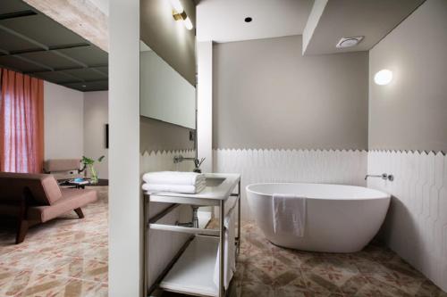 a large white bath tub in a bathroom at Oia Hotel Dadaepo in Busan