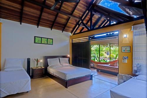 a bedroom with two beds and a balcony at Hotel Amazon Bed And Breakfast in Leticia