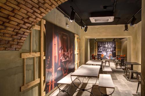 a row of tables and chairs in a room at MEININGER Roma Termini in Rome