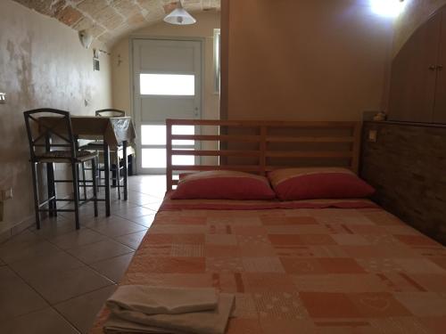 a bed in a room with a table and chairs at Sea Home 2 in Monopoli