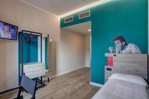 a bedroom with a wall with a painting of a man at MEININGER Roma Termini in Rome