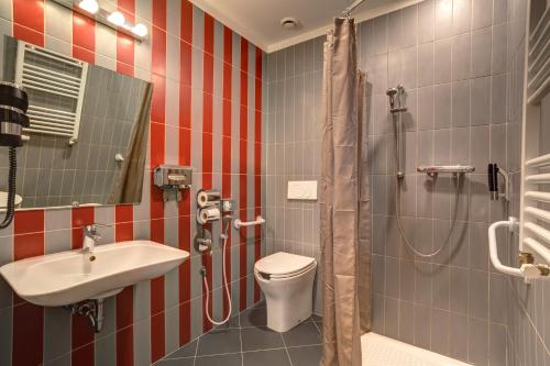 a bathroom with a toilet and a sink and a shower at MEININGER Roma Termini in Rome