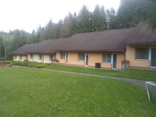 a house with a large yard in front of it at Ośrodek Wczasowy "GRONOSTAJ" in Rajcza