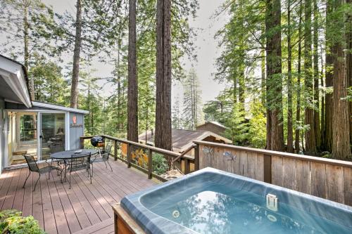 a hot tub on a deck in the woods at Feelin' Beachy in Gualala