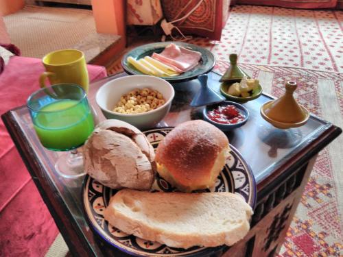 a tray of food with a sandwich and bread and drinks at Porto Riad - Guest House in Porto
