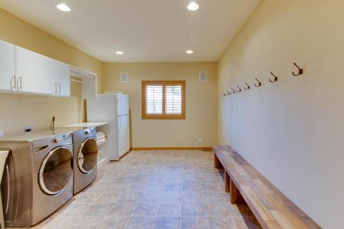 a kitchen with a washer and dryer and a bench at Desperado Dream in Hailey
