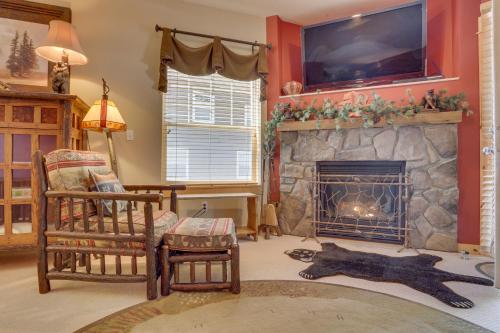a living room with a fireplace with a tv above it at Wild West in Government Camp