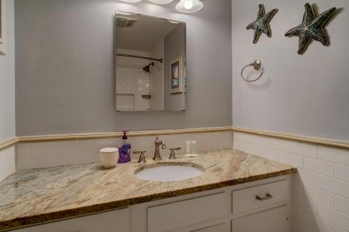 a bathroom with a sink and a mirror at Weeks Pond Charmer in Forestdale