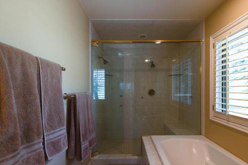 a bathroom with a shower and a tub and a sink at Desperado Dream in Hailey