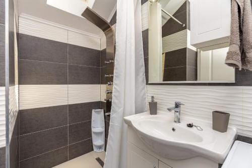 a bathroom with a sink and a shower at Apartment Horizon in Dubrovnik