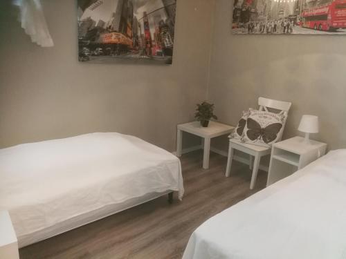 a room with two beds and a chair in it at Hagen in Vennesla