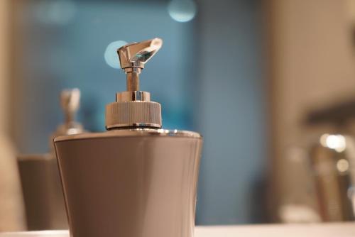 a close up of a soap dispenser on a counter at Appart&Spa in Toulouse
